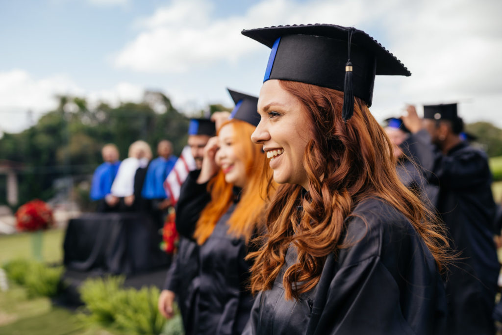 Smiling graduate at graduation ceremony