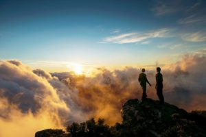 An Impact Trailblazer image of two business professionals on a hill looking at the horizon.