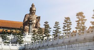 A Chinese statue on top of a temple inspired building in Laozi, China symbolic philosophy of life and leadership