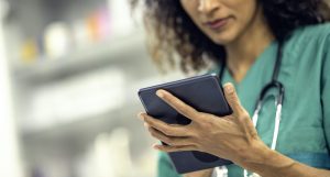 A vet focusing on a tablet.