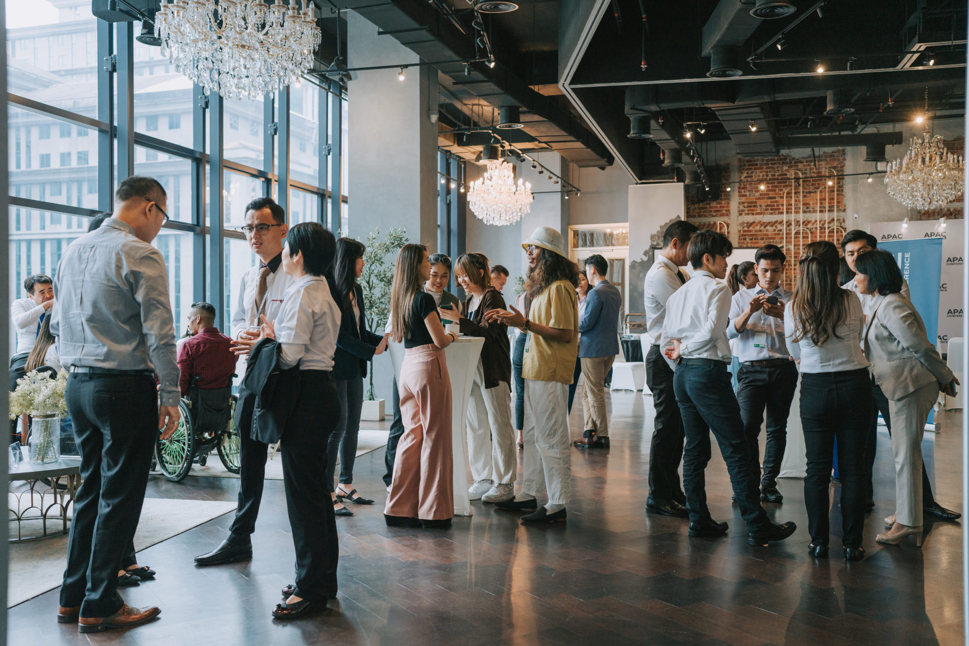 Group of multiracial Asian business participants casual chat after successful conference event