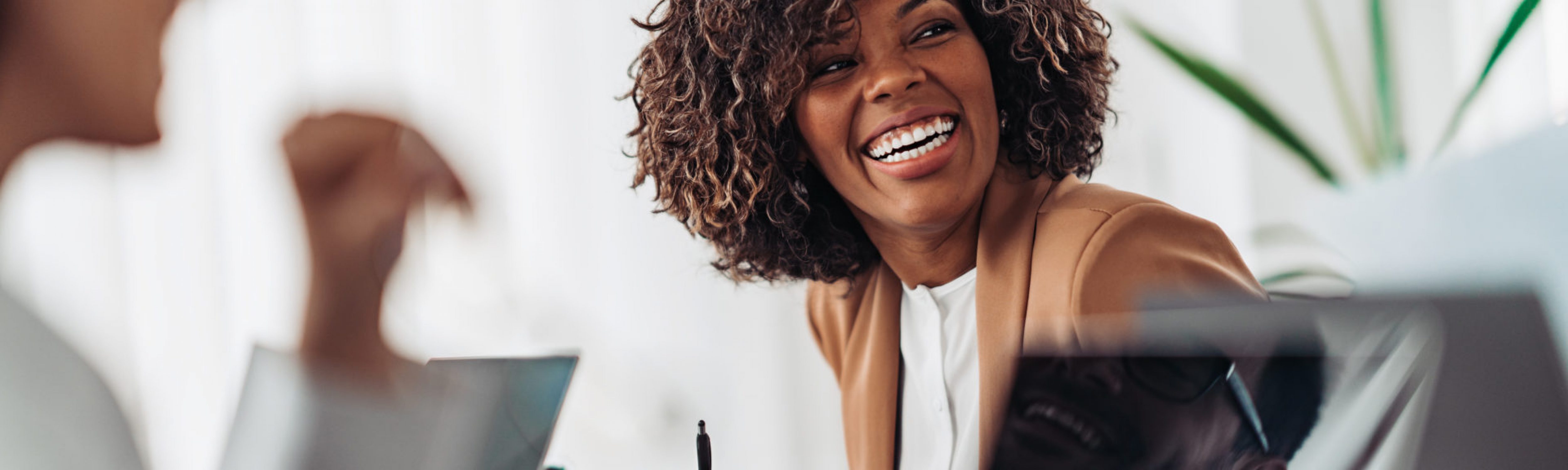 Portrait of cheerful businesswoman smiling at the meeting