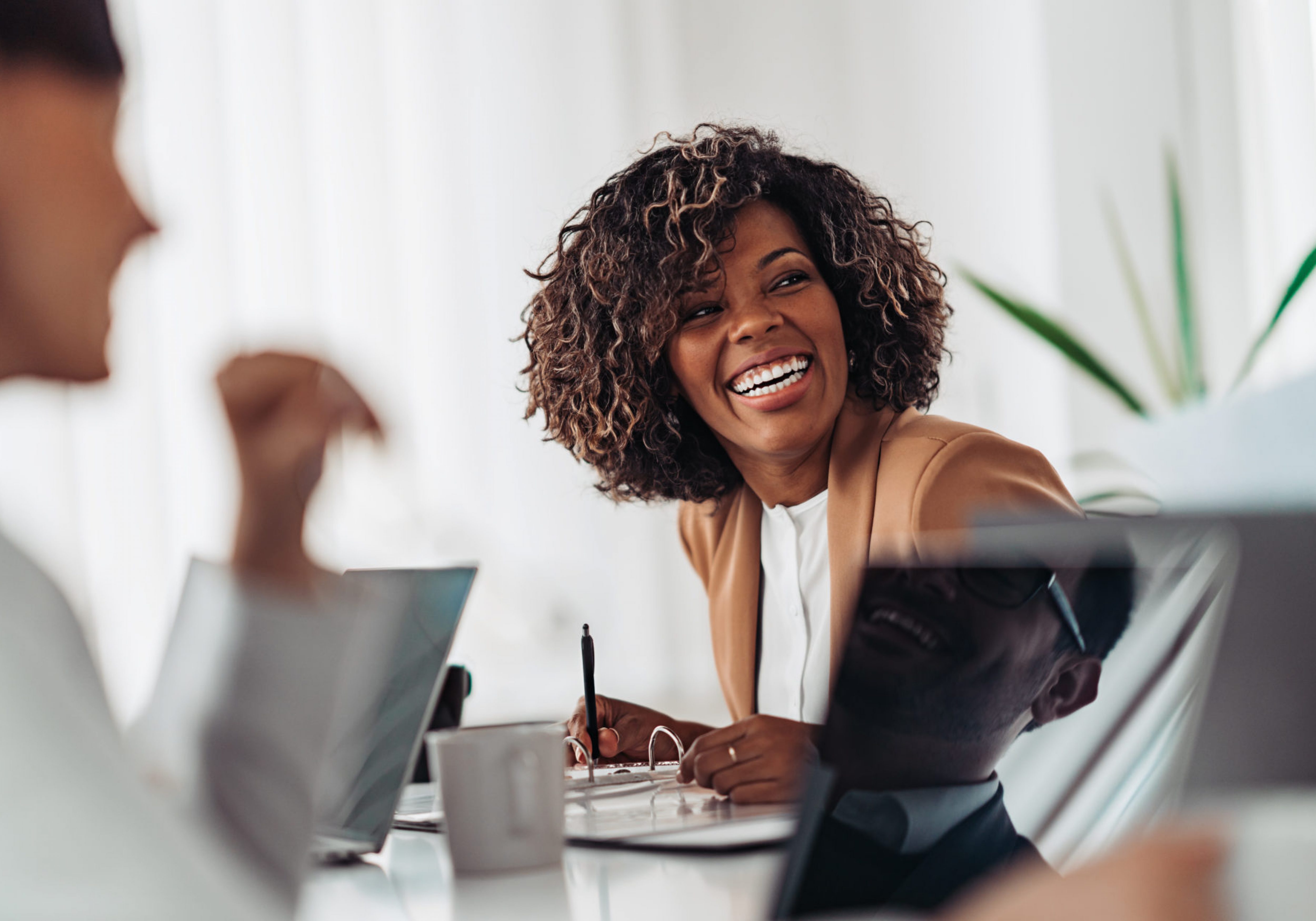 Portrait of cheerful businesswoman smiling at the meeting