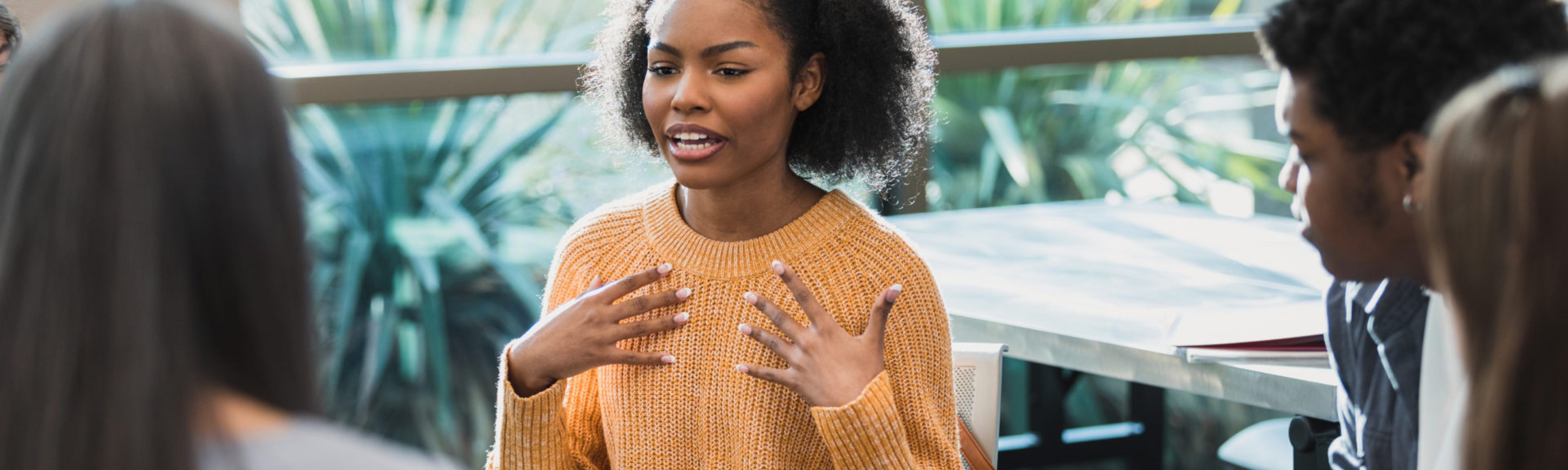 Upset female student talks about emotions during therapy session. World Mental Health Day 2022.