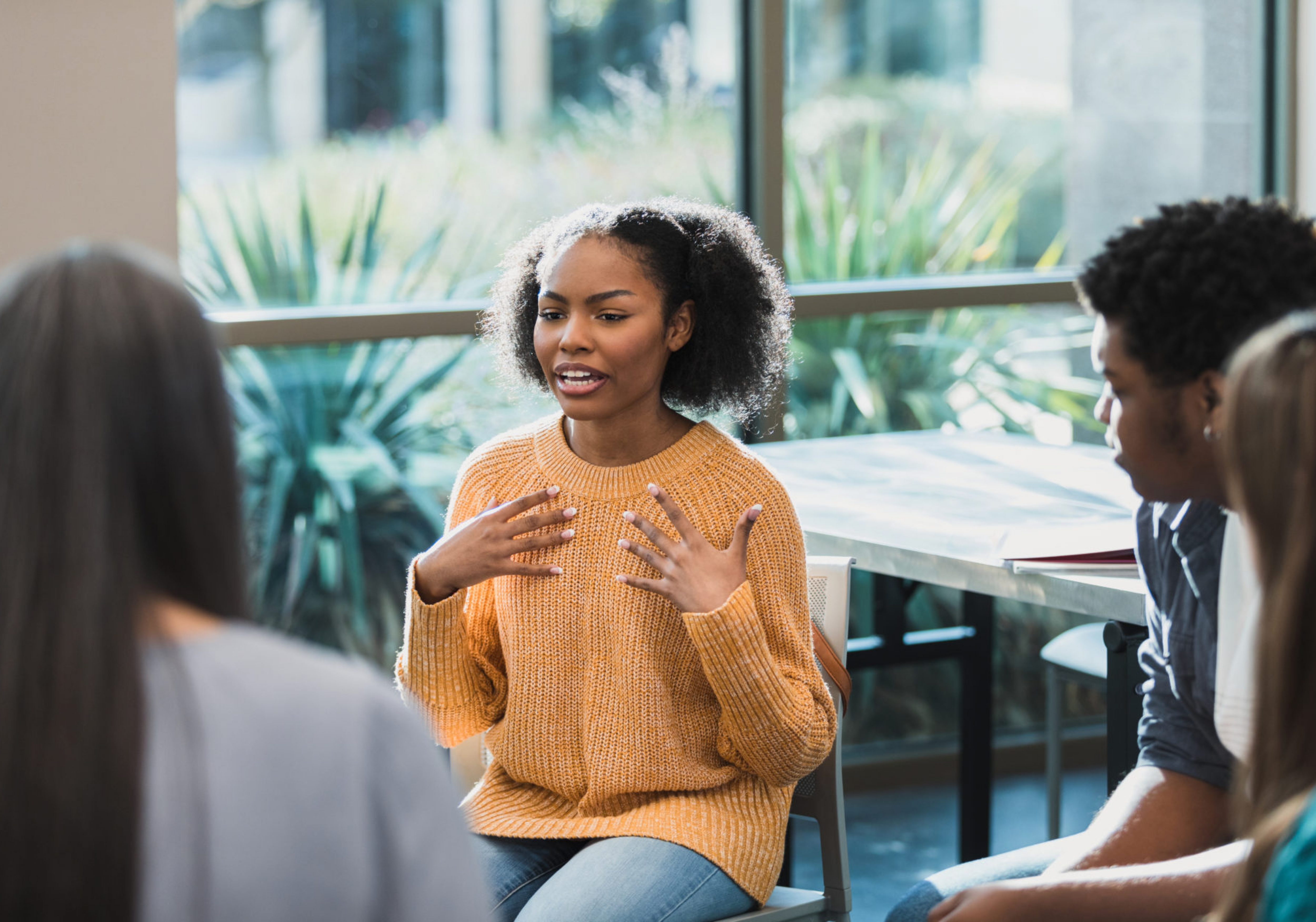 Upset female student talks about emotions during therapy session. World Mental Health Day 2022.