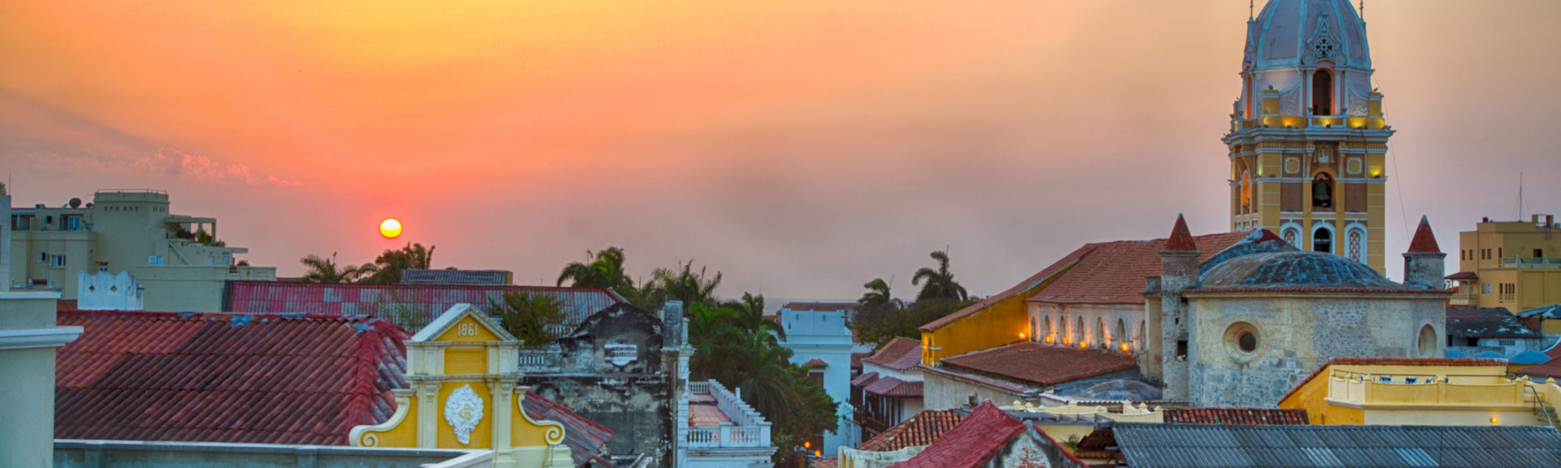 Latin American Capacity Building Workshop Four Image. View over the rooftops of the old city of Cartagena, Colombia, Latin America, during a vibrant sunset. The spire of Cartagena Cathedral stands tall and proud.