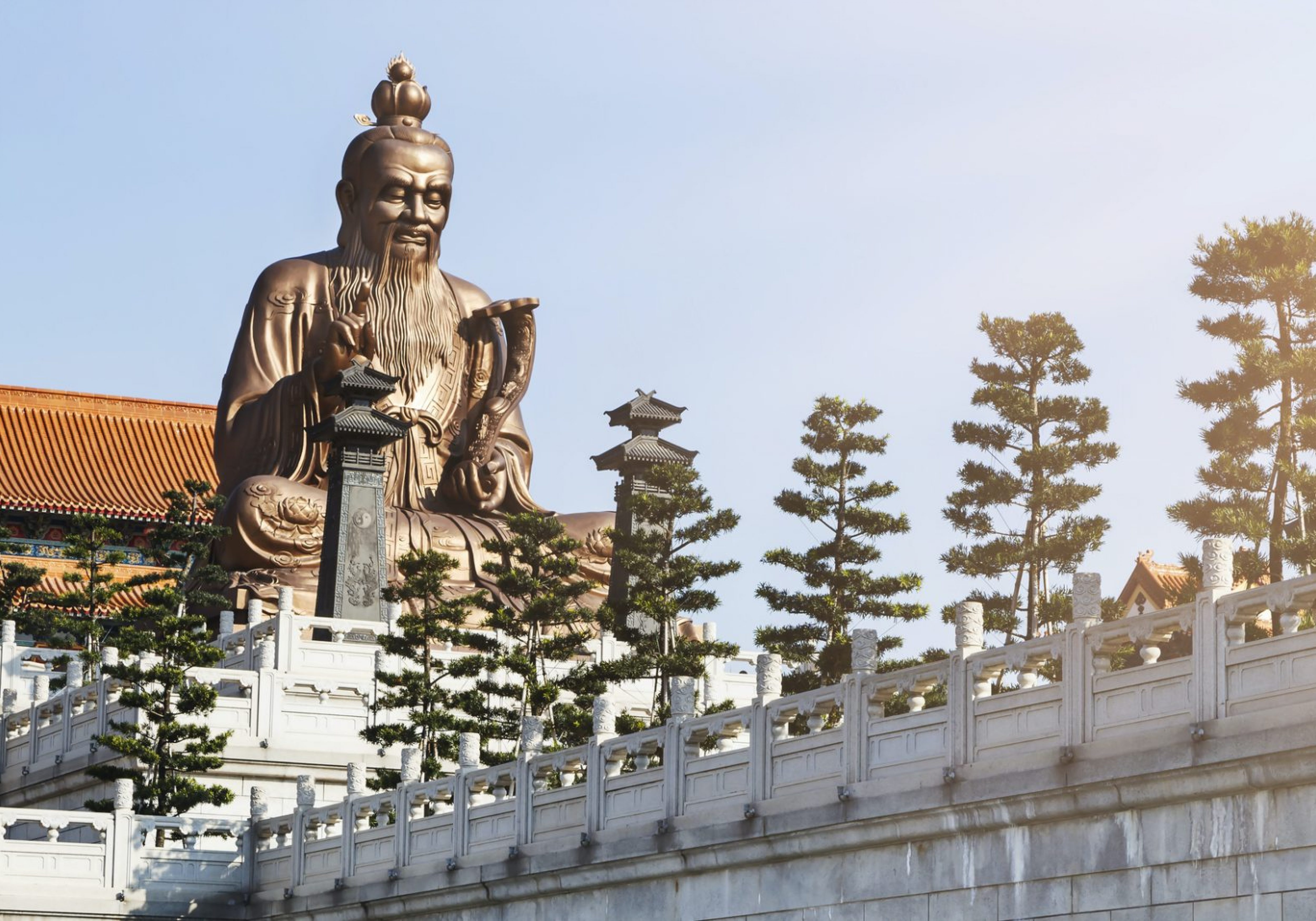 A Chinese statue on top of a temple inspired building in Laozi, China symbolic philosophy of life and leadership