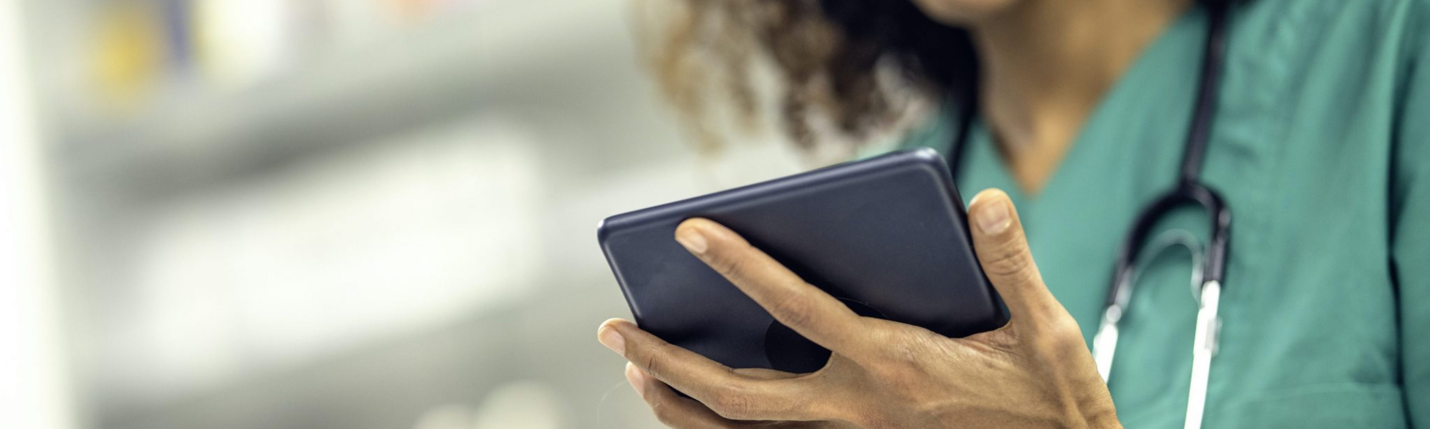 A vet focusing on a tablet.